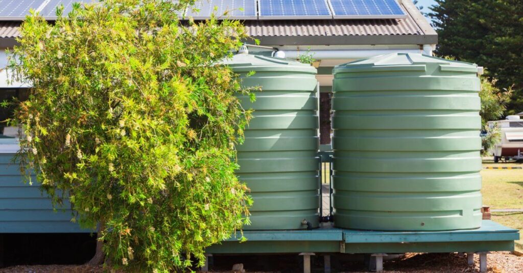 Two large water tanks beside house for practical water storage