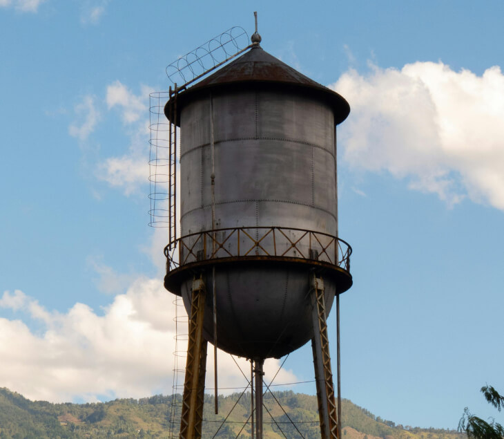 Water tower with metal roof and sturdy access ladder